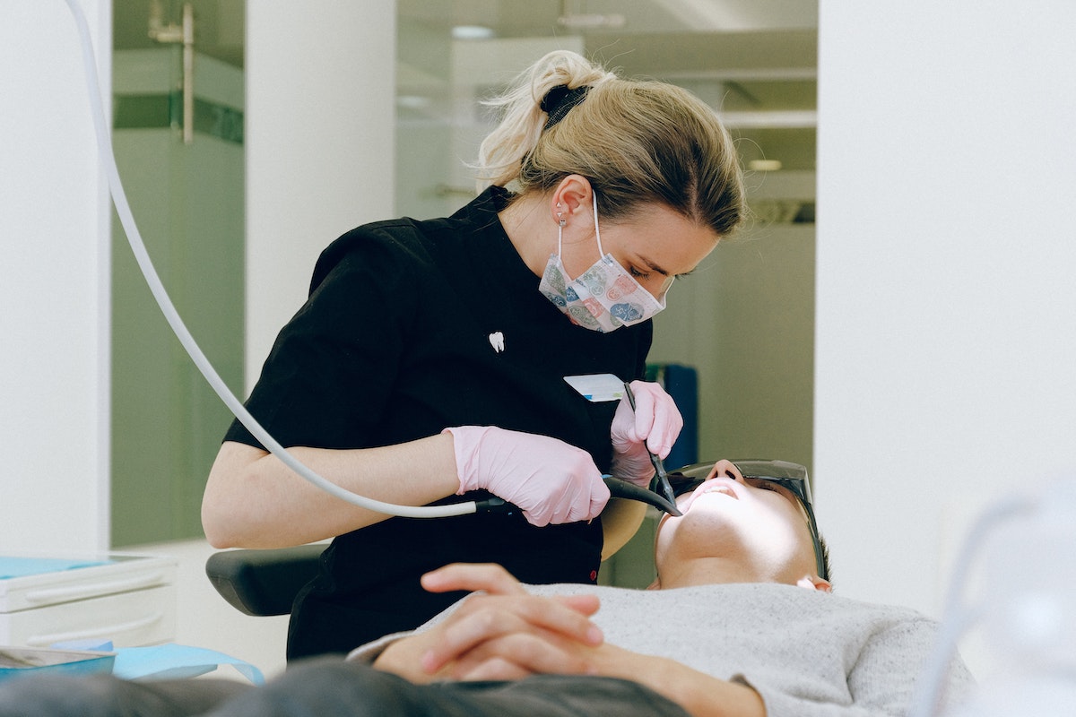 Houston dentist treating a patient who came in after a dental marketing campaign