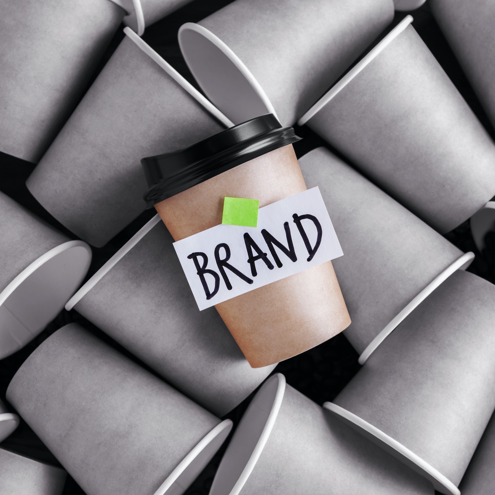 image of a branded coffee cup standing out amongst coffee cups without a brand