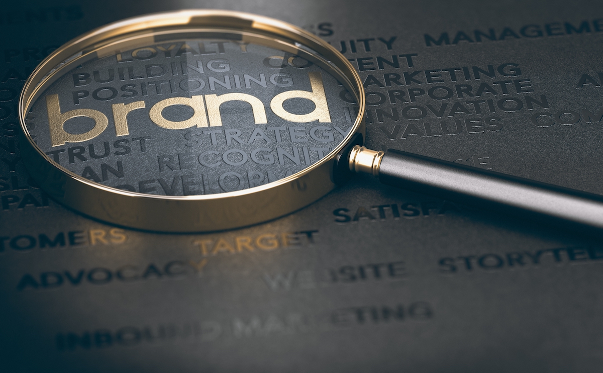 magnifying glass over the word &quot;brand&quot; to signify the importance of creating a brand that stands out