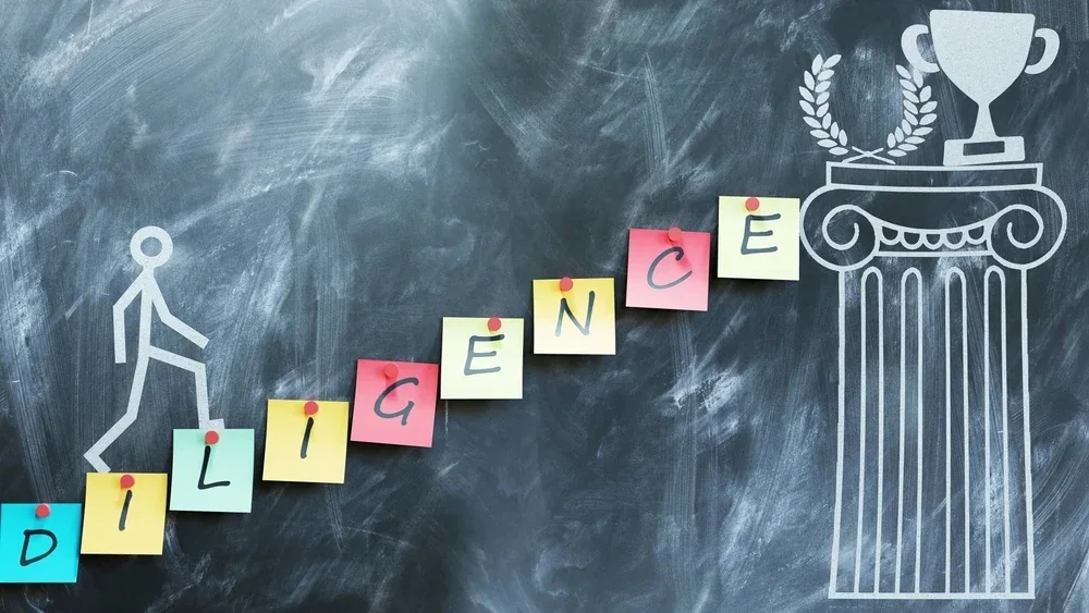 Sticky notes spelling DILIGENCE forming steps up to a trophy drawn on a chalkboard
