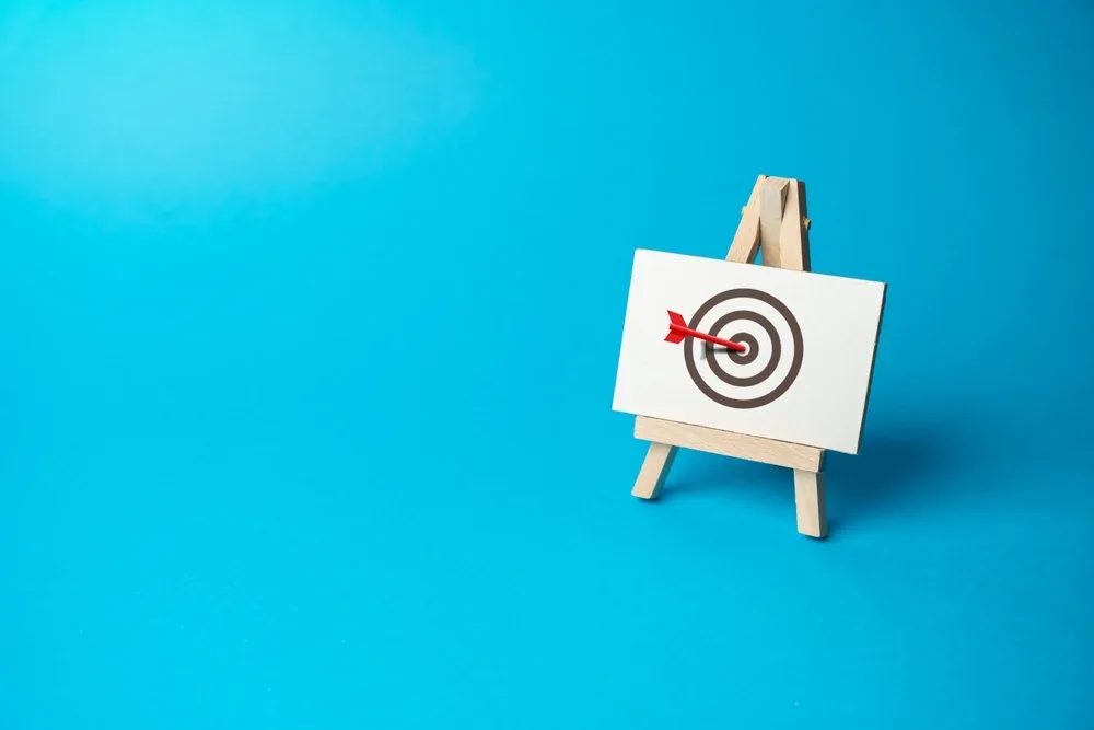 Arrow hitting the bullseye of a target on an easel — checking your site against the fundamentals
