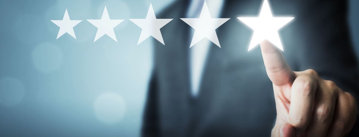 person in a suit submitting a 5 star review for a local business