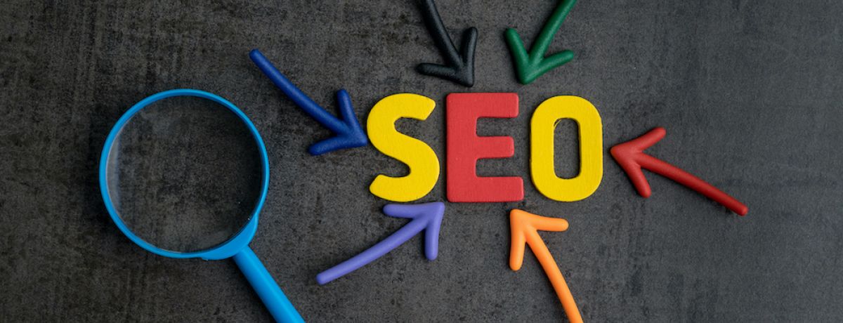 SEO spelled out in color with a magnifying glass