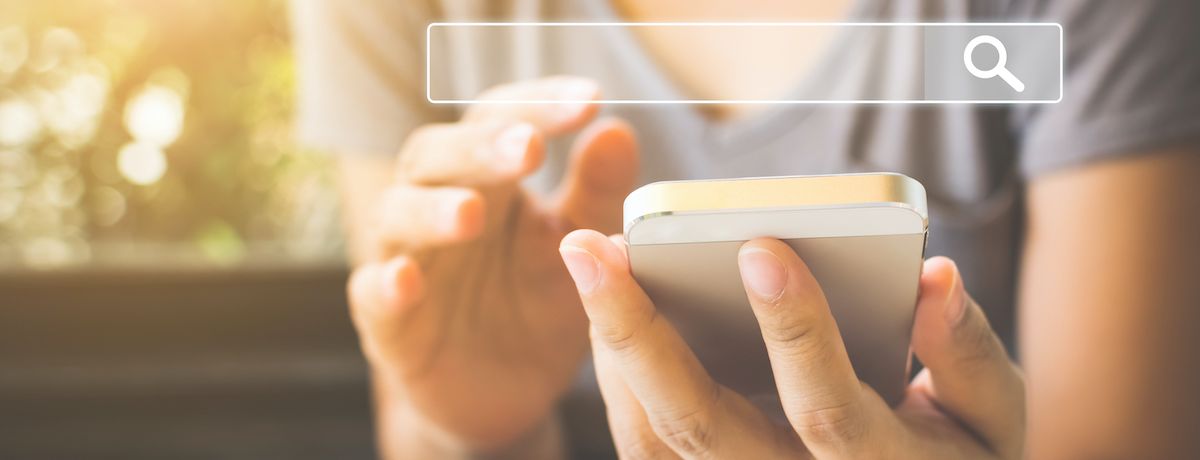 Woman browsing Google on smartphone for Houston marketing strategy to boost SEO rank