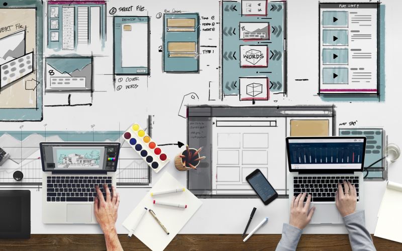 A pair of designers performing Houston web design to help improve a business's Houston digital marketing strategy.