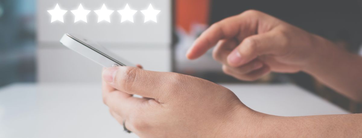 person submitting a 5 start review on their phone for a houston business