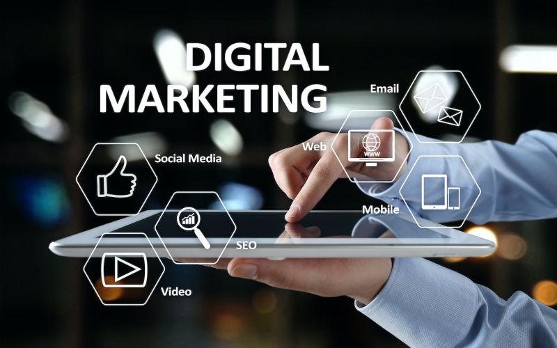 marketing expert with a tablet in hand consisting of social media, SEO, video, email, website, and mobile