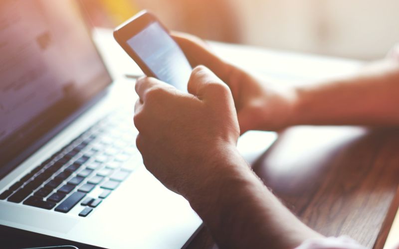 Customer browsing a Houston business's website on laptop and on mobile