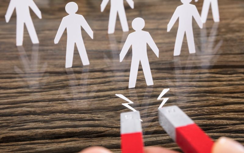 Business owner holding a magnet that demonstrates lead generation