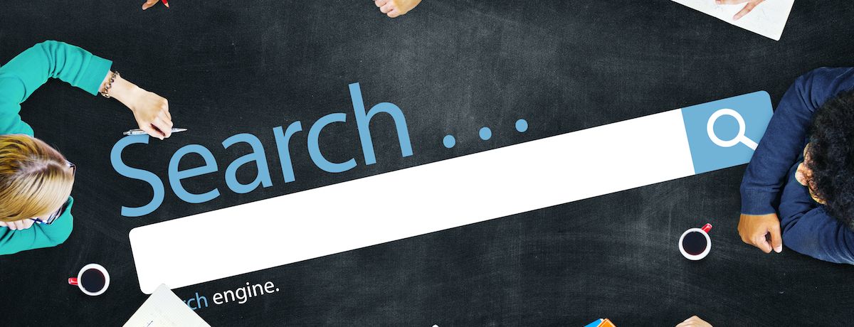 houston marketing professionals sitting at a table with a SEO search bar graphic in the middle