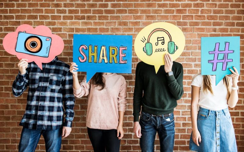 houston social media marketing team holding posters of different icons